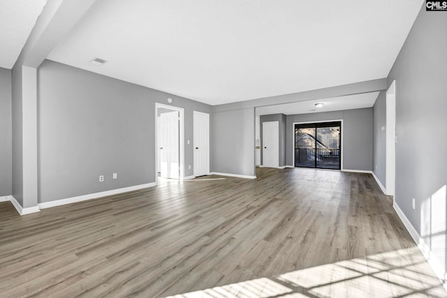 unfurnished living room featuring light wood-type flooring