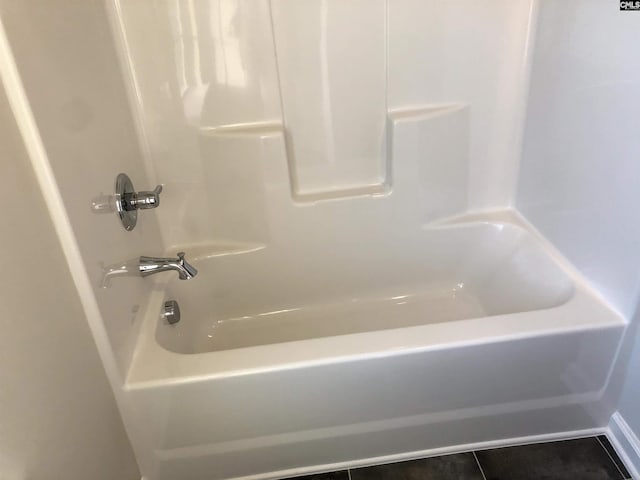 bathroom featuring tile patterned flooring and bathtub / shower combination