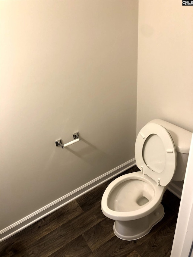 bathroom with hardwood / wood-style flooring and toilet