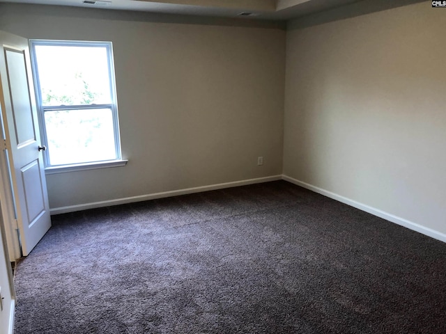 empty room with dark carpet