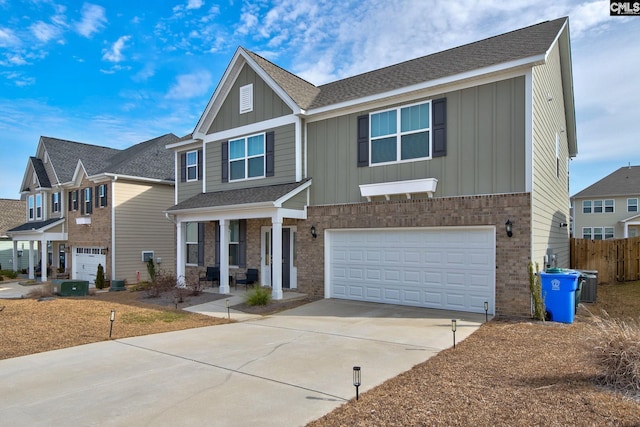 view of front of property featuring a garage, a porch, and central AC