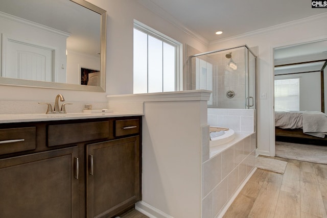 bathroom with vanity, crown molding, plus walk in shower, and hardwood / wood-style flooring