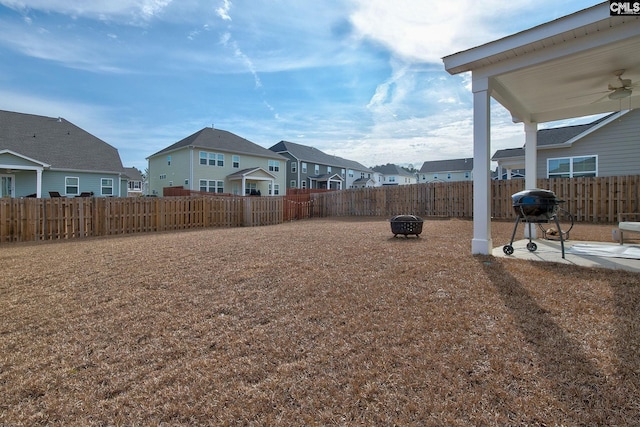 view of yard with a patio, ceiling fan, and an outdoor fire pit