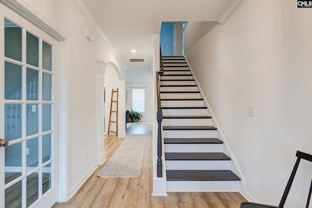 stairway featuring hardwood / wood-style flooring and ornamental molding