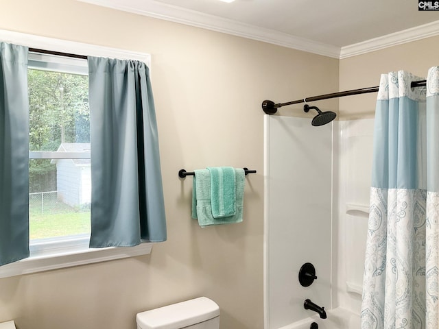 bathroom with ornamental molding, plenty of natural light, shower / tub combo, and toilet