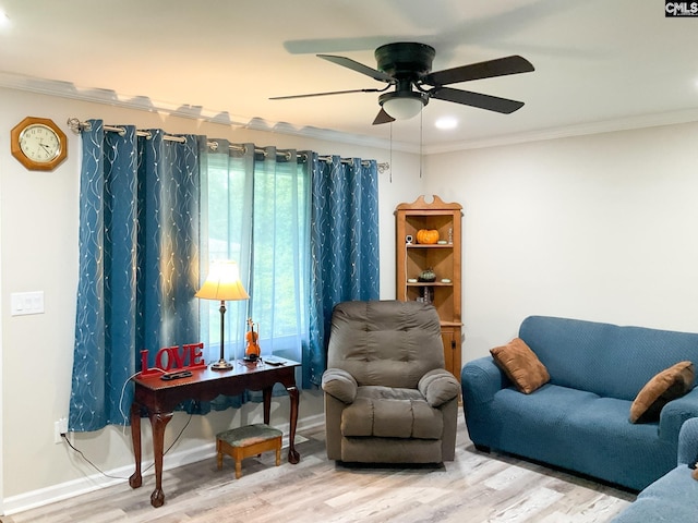 sitting room with ornamental molding, wood-type flooring, and ceiling fan