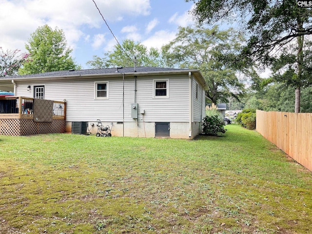 rear view of house featuring a yard, central AC, and a deck