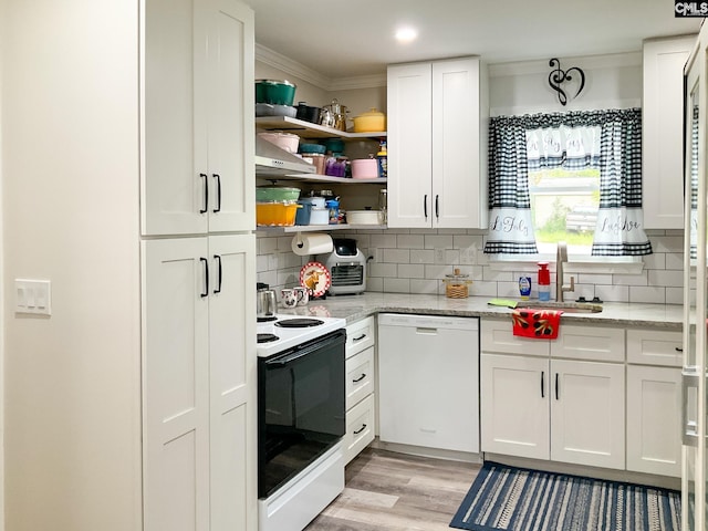 kitchen with electric stove, crown molding, white dishwasher, light stone counters, and white cabinets