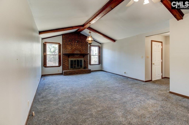 unfurnished living room with a brick fireplace, lofted ceiling with beams, ceiling fan, and carpet flooring