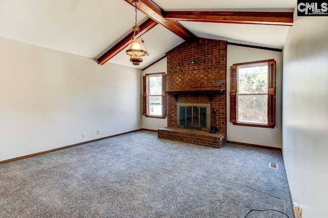 unfurnished living room featuring lofted ceiling with beams, a brick fireplace, and carpet flooring