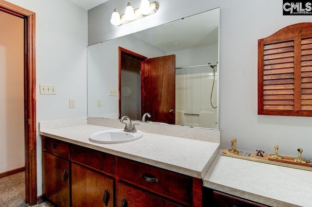 bathroom featuring vanity and a shower