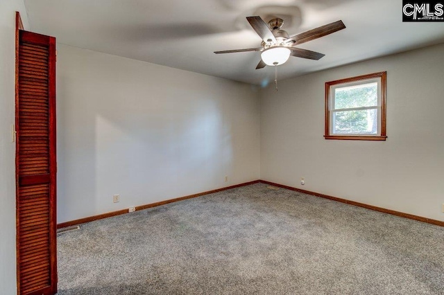 carpeted spare room with ceiling fan