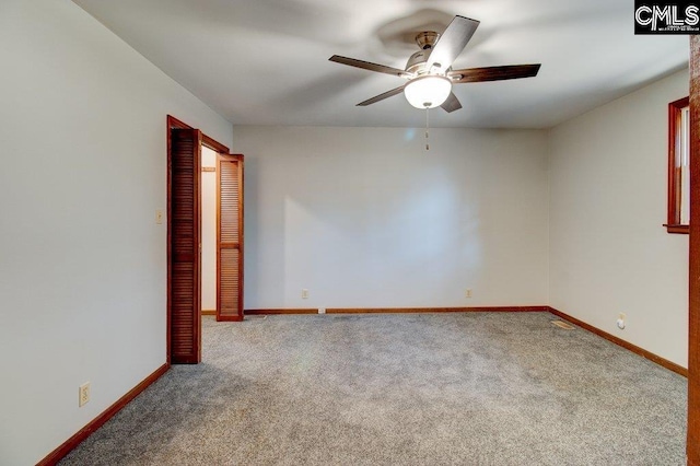 spare room with carpet floors and ceiling fan