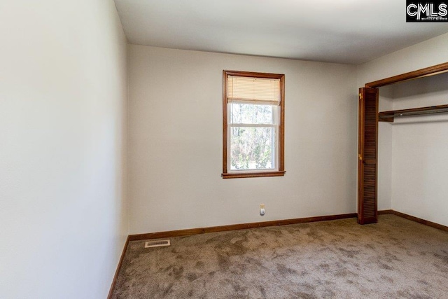 unfurnished bedroom with a closet and carpet