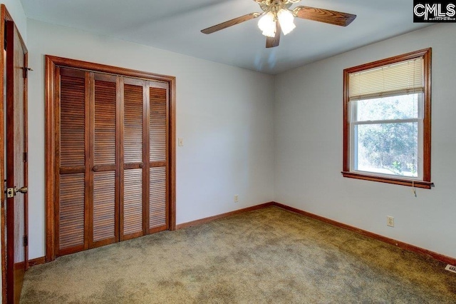 unfurnished bedroom with a closet, ceiling fan, and carpet flooring