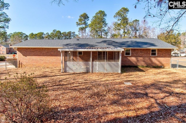 rear view of property with a sunroom