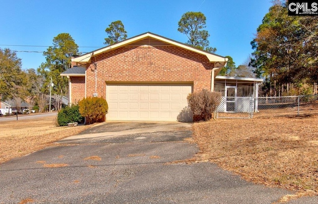 view of front of house featuring a garage and a sunroom