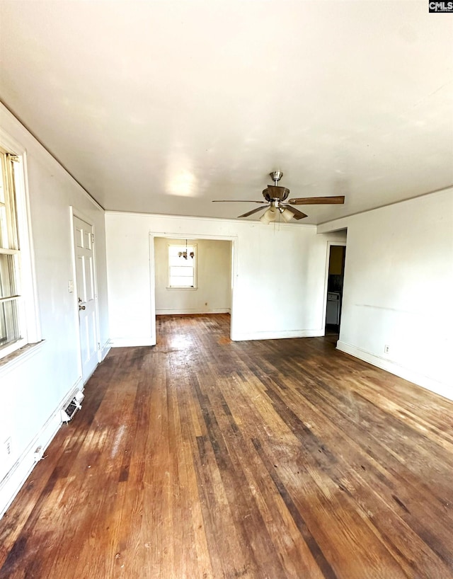 unfurnished living room with ceiling fan and dark hardwood / wood-style flooring