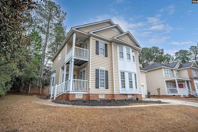 view of front facade featuring a balcony and a front lawn