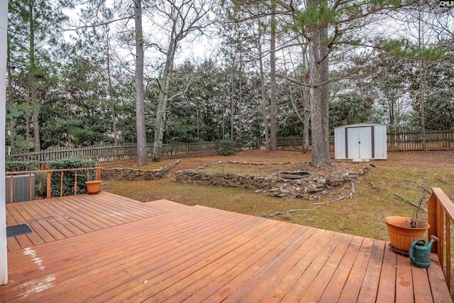 deck with a fire pit and a storage unit