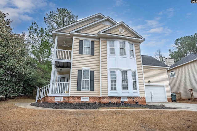 view of property featuring ceiling fan, a front lawn, and a balcony