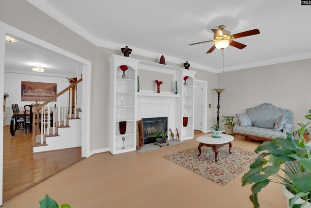 living room with ceiling fan, ornamental molding, and hardwood / wood-style floors