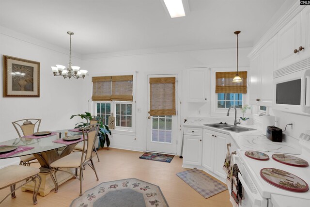 kitchen featuring sink, crown molding, decorative light fixtures, white appliances, and white cabinets