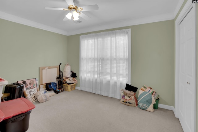 playroom featuring ceiling fan, ornamental molding, and carpet flooring