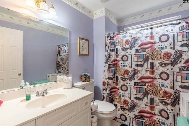 bathroom featuring vanity, toilet, and curtained shower