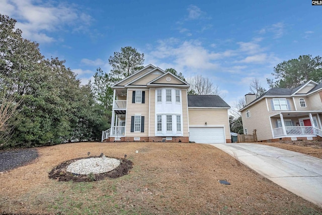 view of front of property featuring a garage, a front lawn, and a balcony