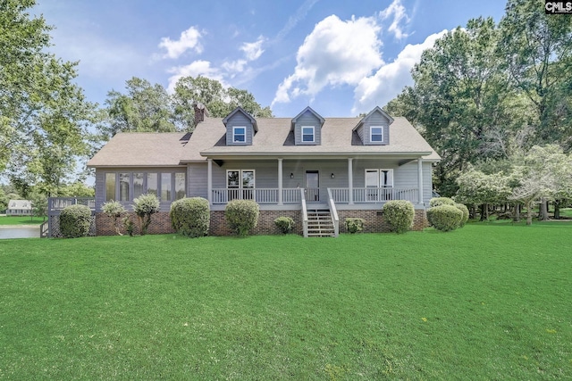 cape cod-style house featuring a porch and a front yard