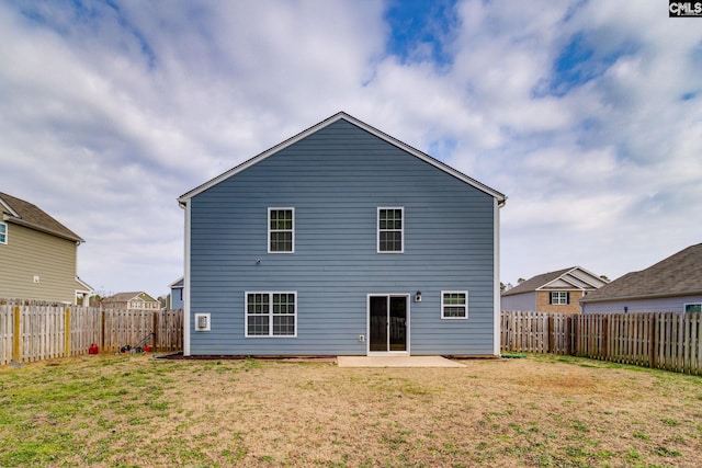 rear view of property featuring a patio area and a lawn