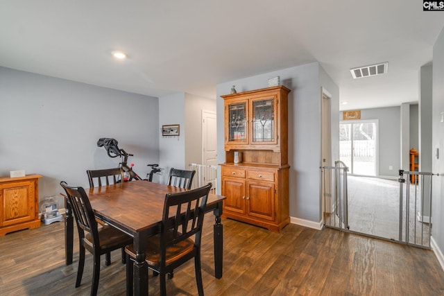 dining room with dark hardwood / wood-style flooring