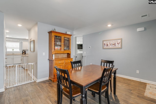 dining space with light hardwood / wood-style floors