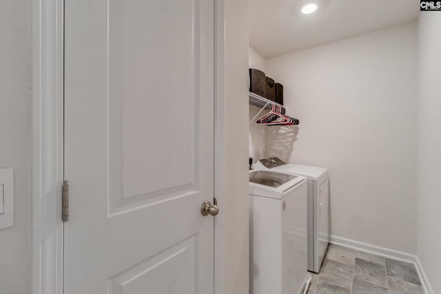 clothes washing area featuring washer and dryer