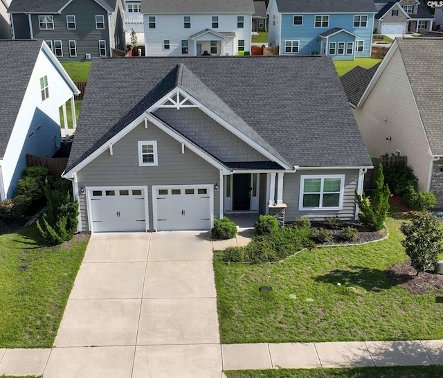 view of front of property featuring a garage and a front yard