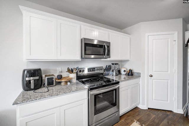 kitchen featuring light stone counters, stainless steel appliances, dark hardwood / wood-style floors, and white cabinets