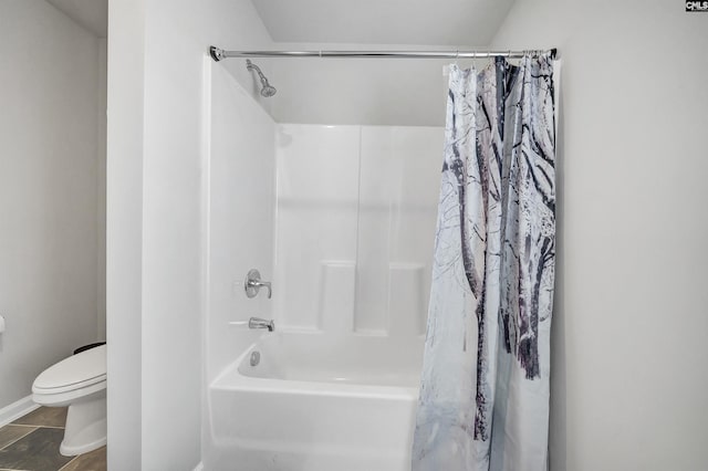 bathroom with tile patterned floors, toilet, and shower / tub combo