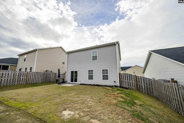 rear view of house featuring a yard and a patio area