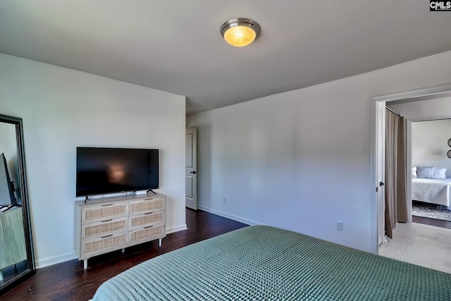 bedroom with dark hardwood / wood-style flooring