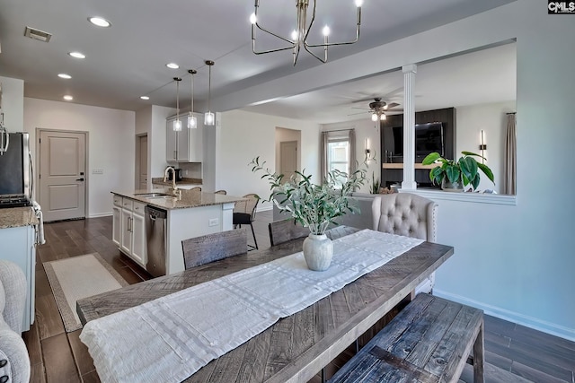 dining space featuring ceiling fan, sink, and dark hardwood / wood-style flooring