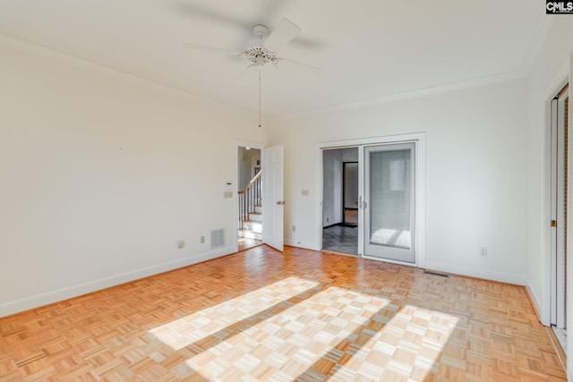 empty room featuring light parquet flooring, ceiling fan, and crown molding