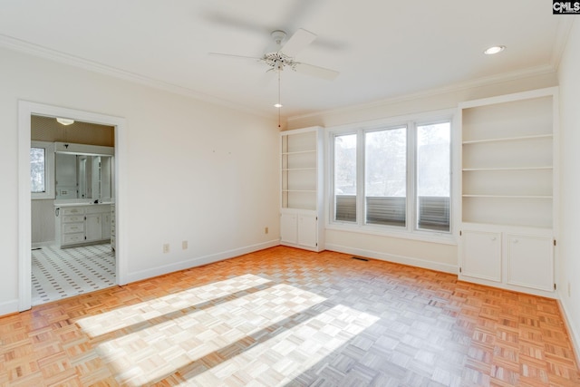 empty room featuring crown molding, ceiling fan, and light parquet floors