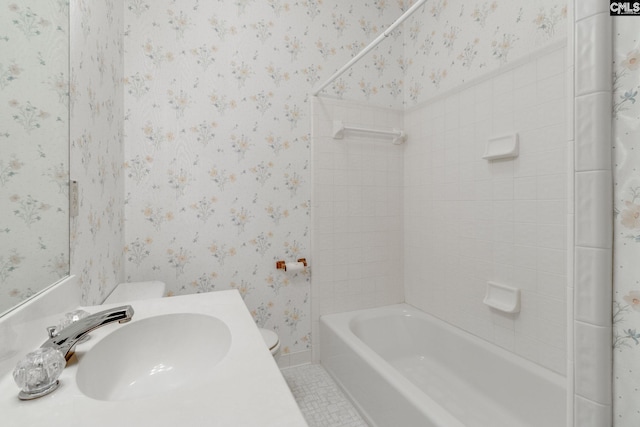 full bathroom with tile patterned flooring, tiled shower / bath, sink, and toilet