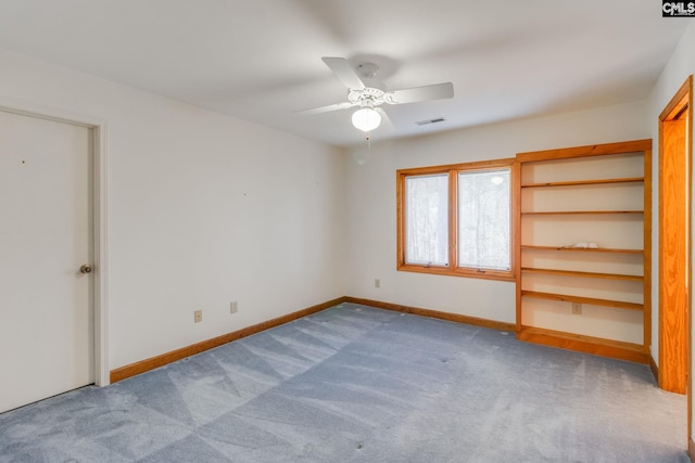 unfurnished bedroom featuring light colored carpet and ceiling fan