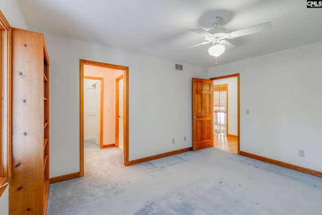 unfurnished bedroom featuring light colored carpet and ceiling fan