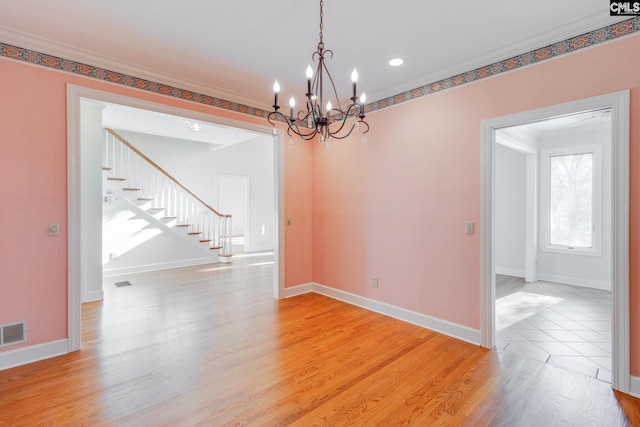 unfurnished room featuring crown molding and light wood-type flooring