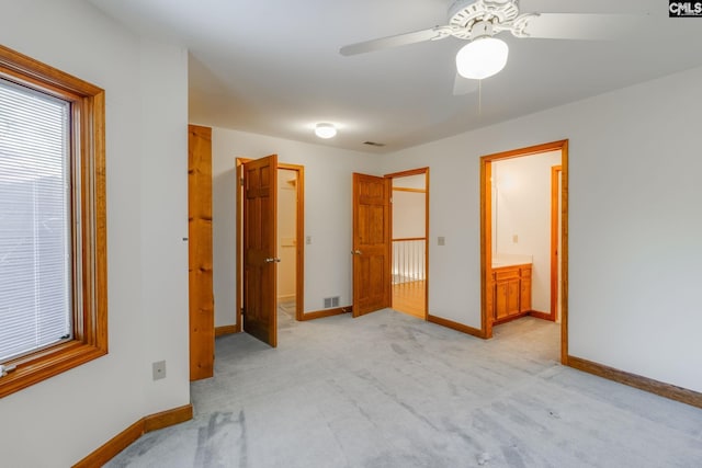 carpeted bedroom with ceiling fan and ensuite bathroom