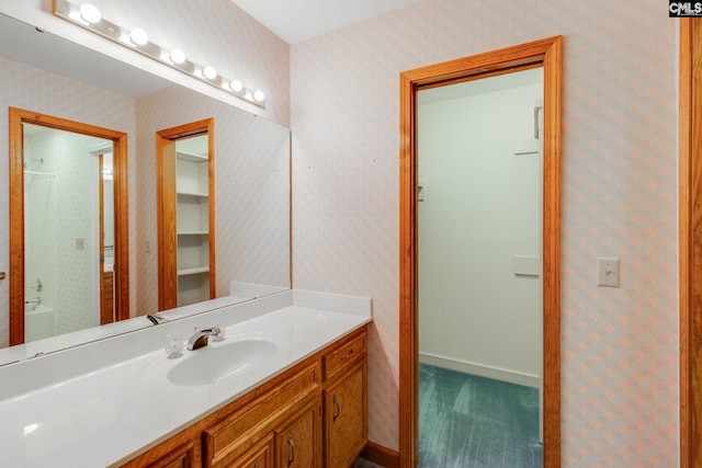 bathroom featuring vanity and a tub