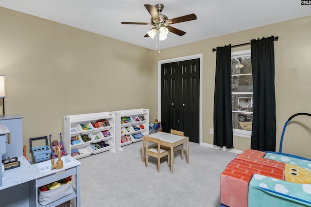 recreation room with carpet floors and ceiling fan